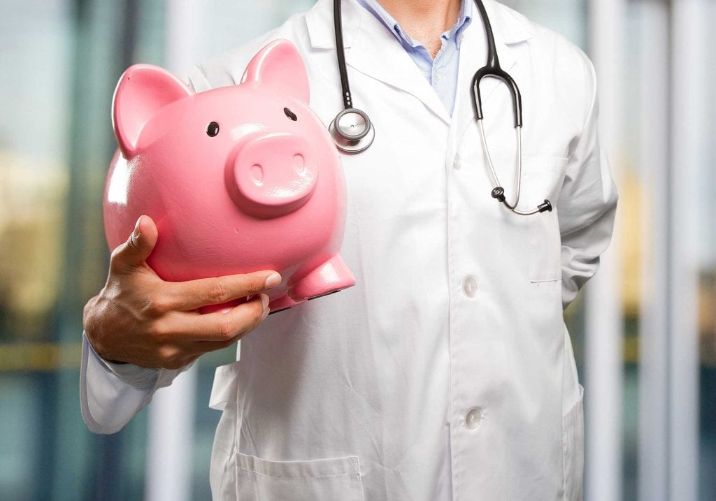 doctor holding piggy bank