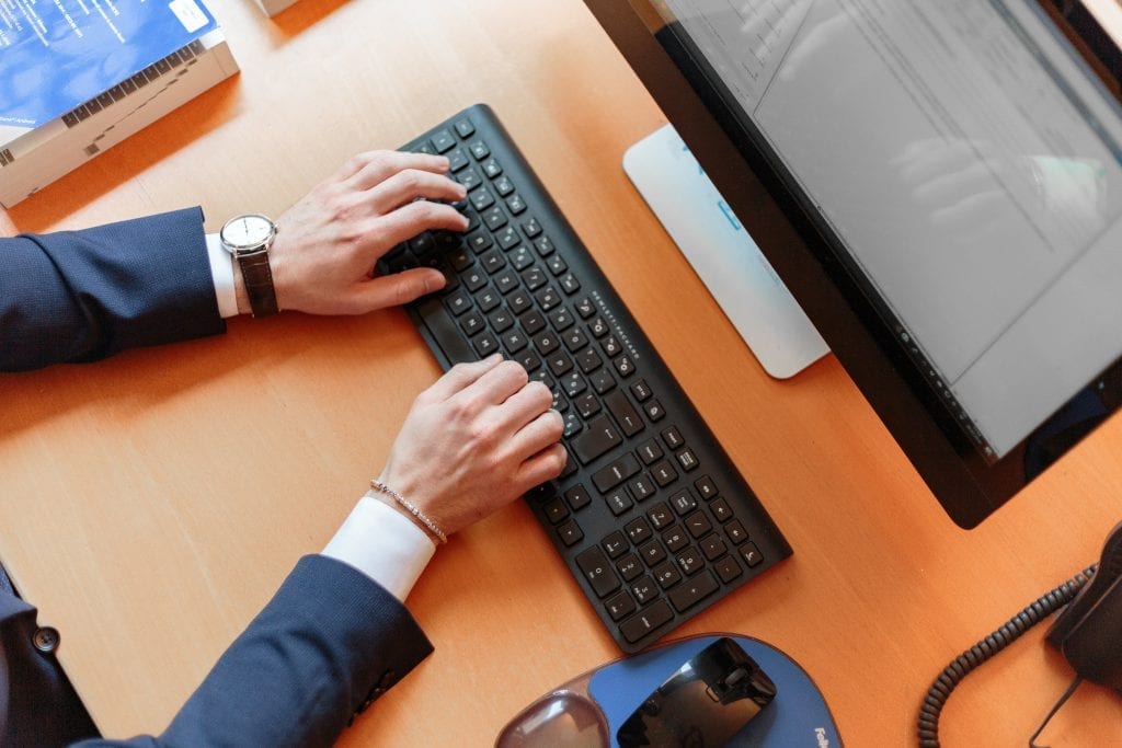 person typing on computer